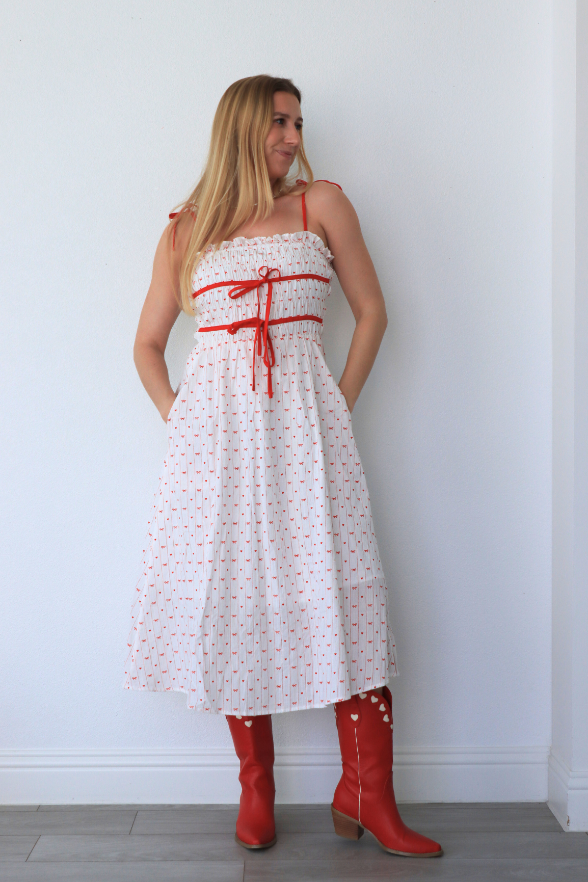 girl wearing white dress with red heart detailing