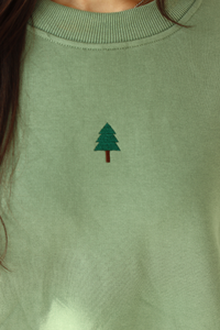 close up of embroidered tree in the center of crewneck 