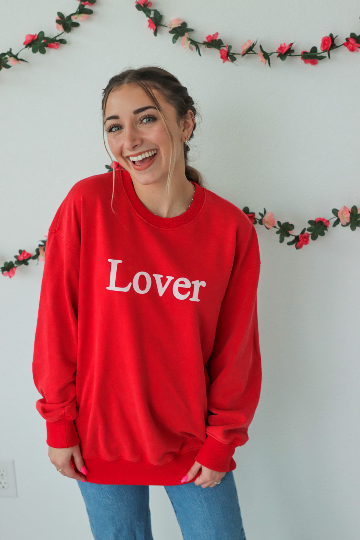 girl wearing red "Lover" crewneck sweatshirt