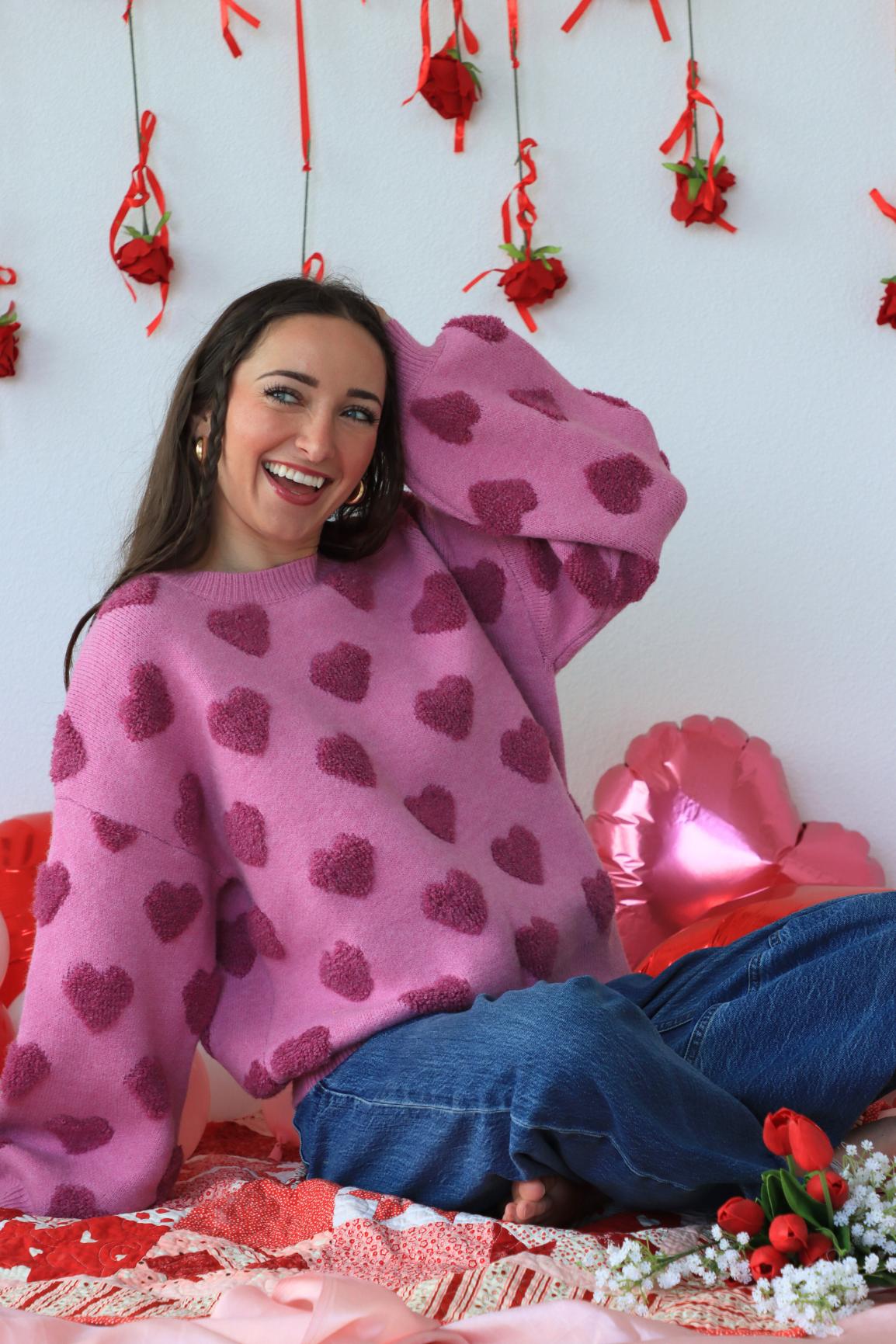 girl wearing pink heart sweater