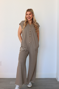 girl wearing brown and cream striped jumpsuit