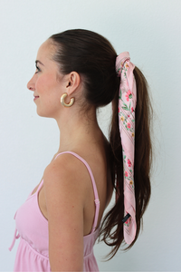 woman wearing pink scarf on her ponytail