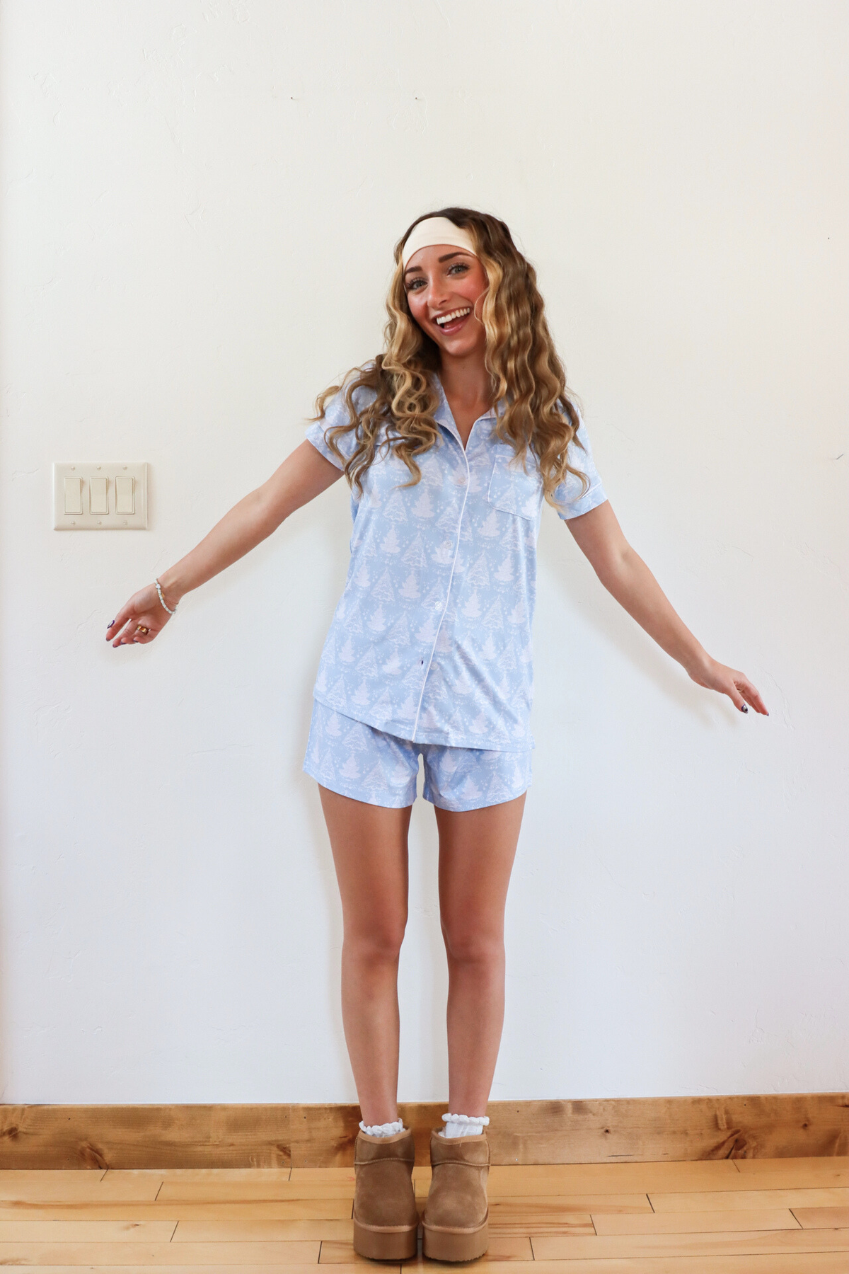 girl wearing light blue christmas tree pajama set