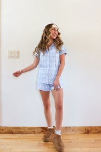 girl wearing light blue christmas tree pajama set