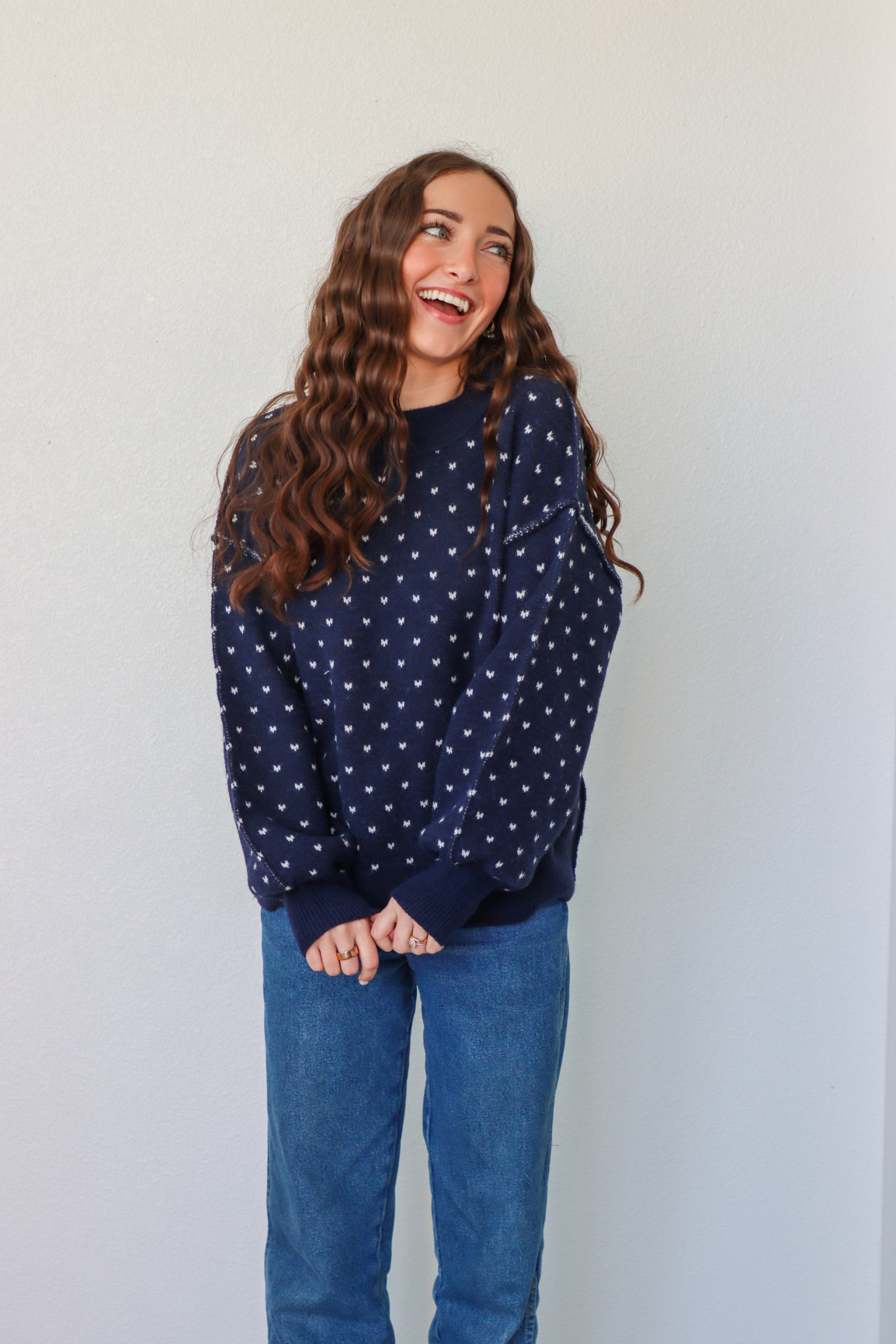 girl wearing navy heart knit sweater