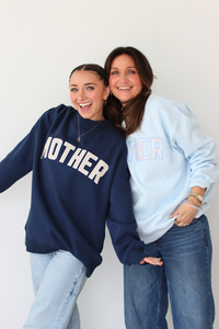 Two women wearing MOTHER sweatshirts