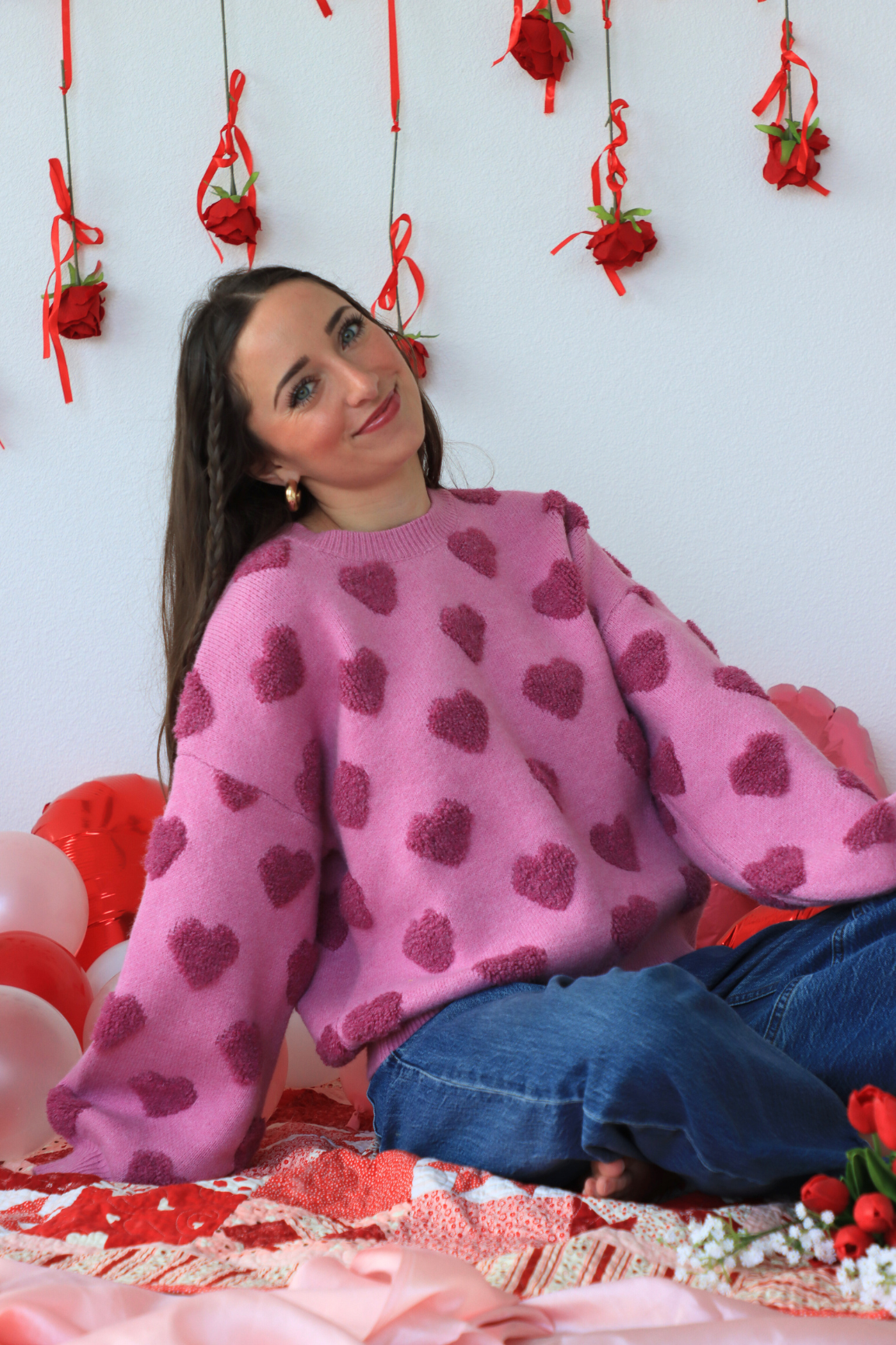 girl wearing pink heart sweater