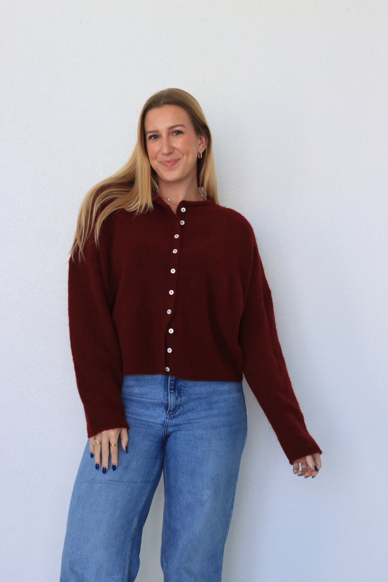girl wearing dark red cardigan