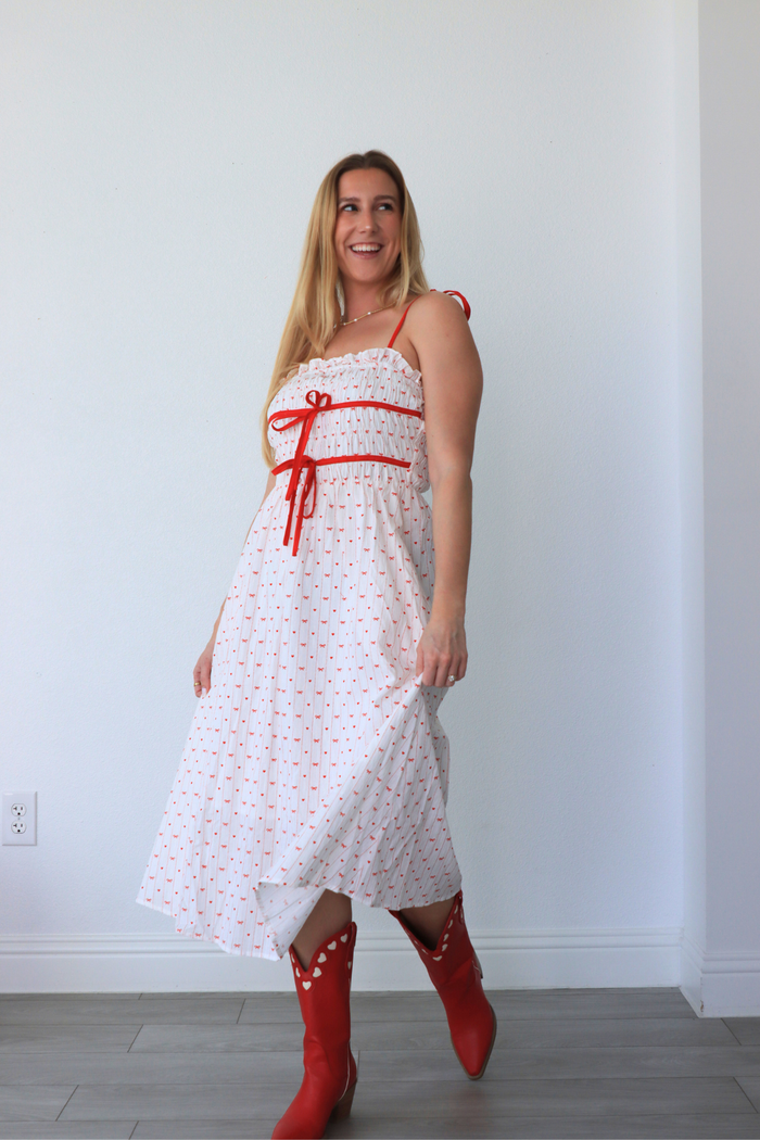 girl wearing white dress with red heart detailing