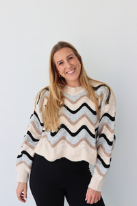 Woman wearing a striped sweater against a plain background