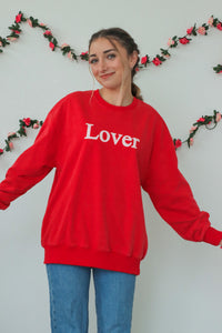 girl wearing red "Lover" crewneck sweatshirt