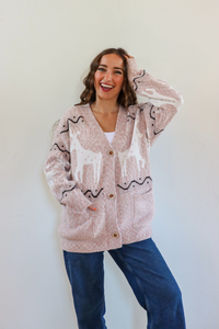 girl wearing pink holiday cardigan