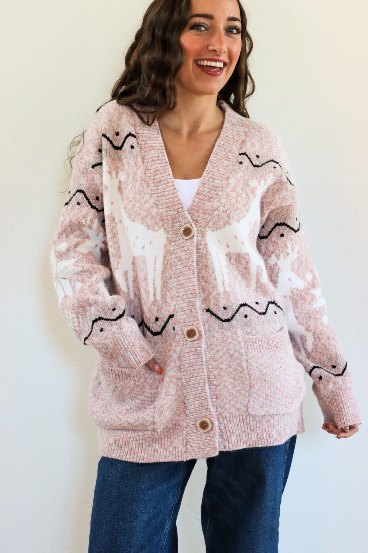 girl wearing pink holiday cardigan