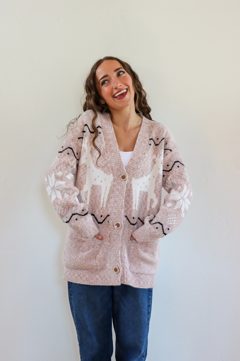 girl wearing pink holiday cardigan
