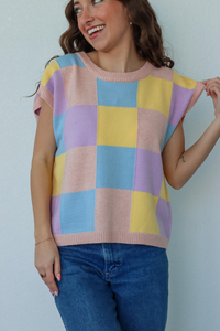 girl wearing blue, yellow, and purple knit short sleeve top