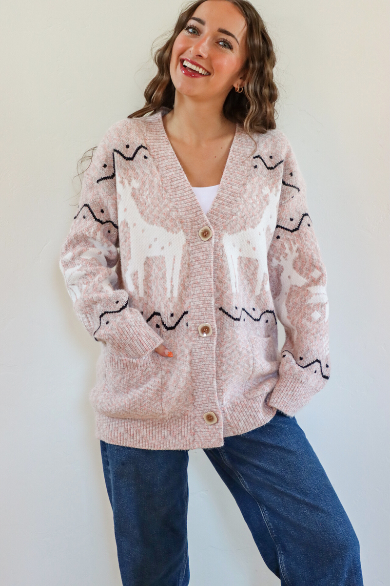 girl wearing pink holiday cardigan