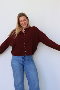 girl wearing dark red cardigan