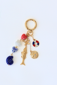 Keychain with various charms on a white background
