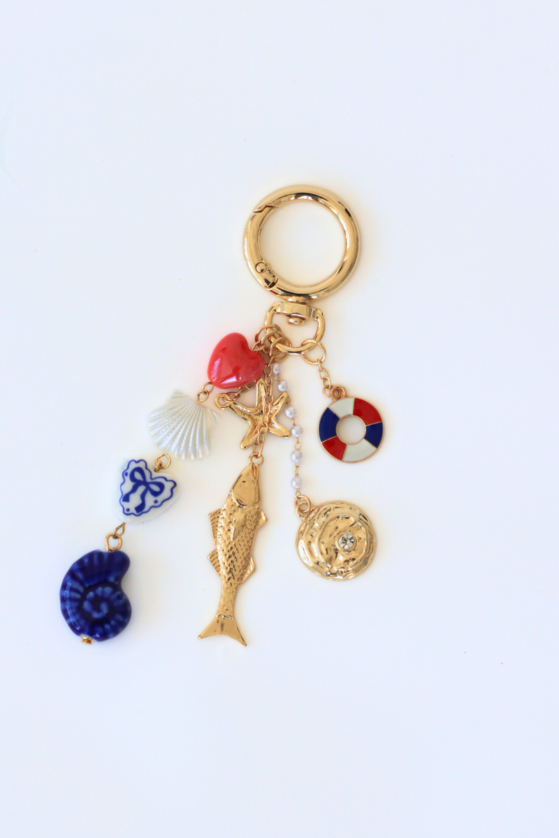 Keychain with various charms on a white background