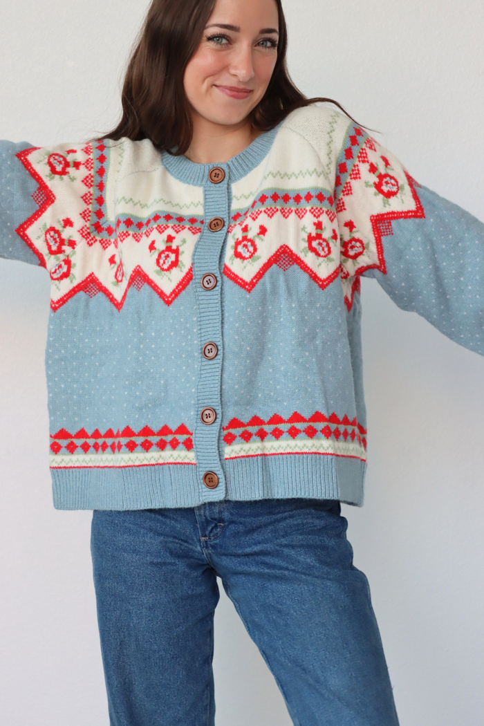 girl wearing light blue knit cardigan