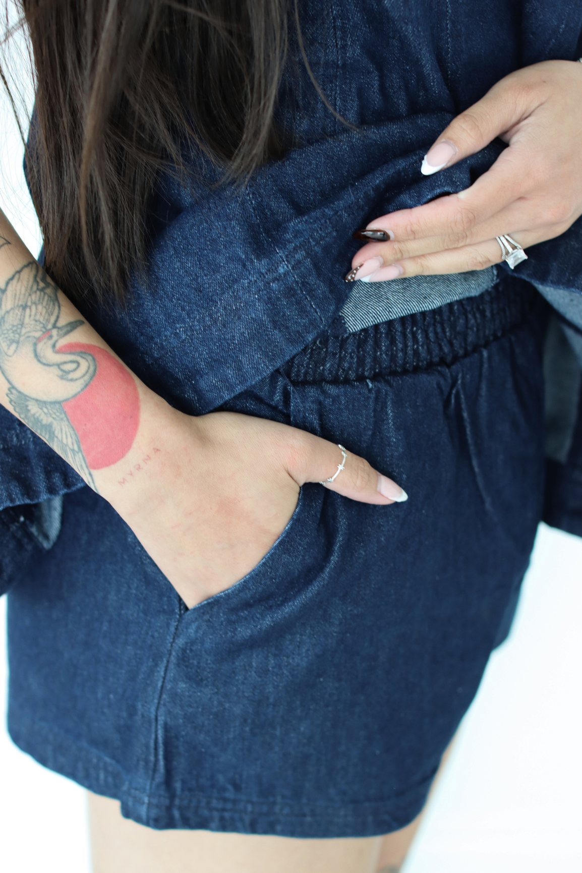 Woman wearing a navy blue outfit set with pockets 