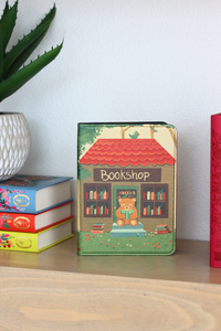 Colorful kindle with 'Bookshop' design on a wooden surface