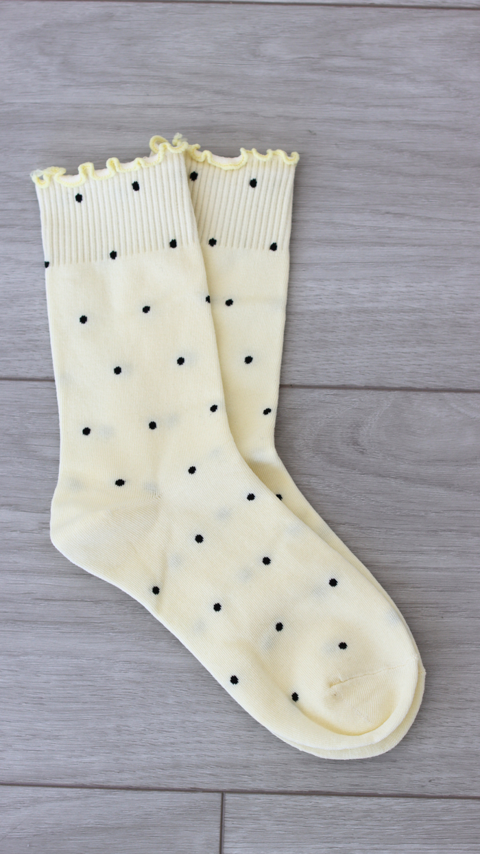 yellow sock with navy blue polka dots 
