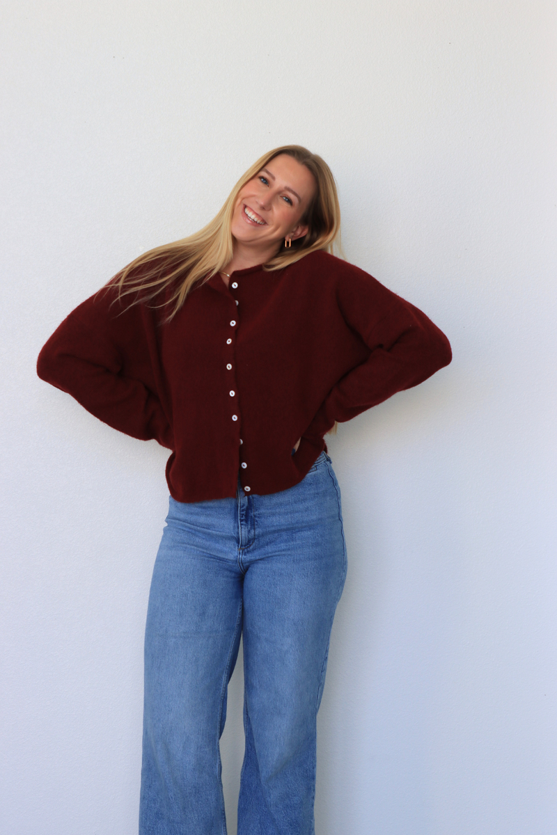 girl wearing dark red cardigan