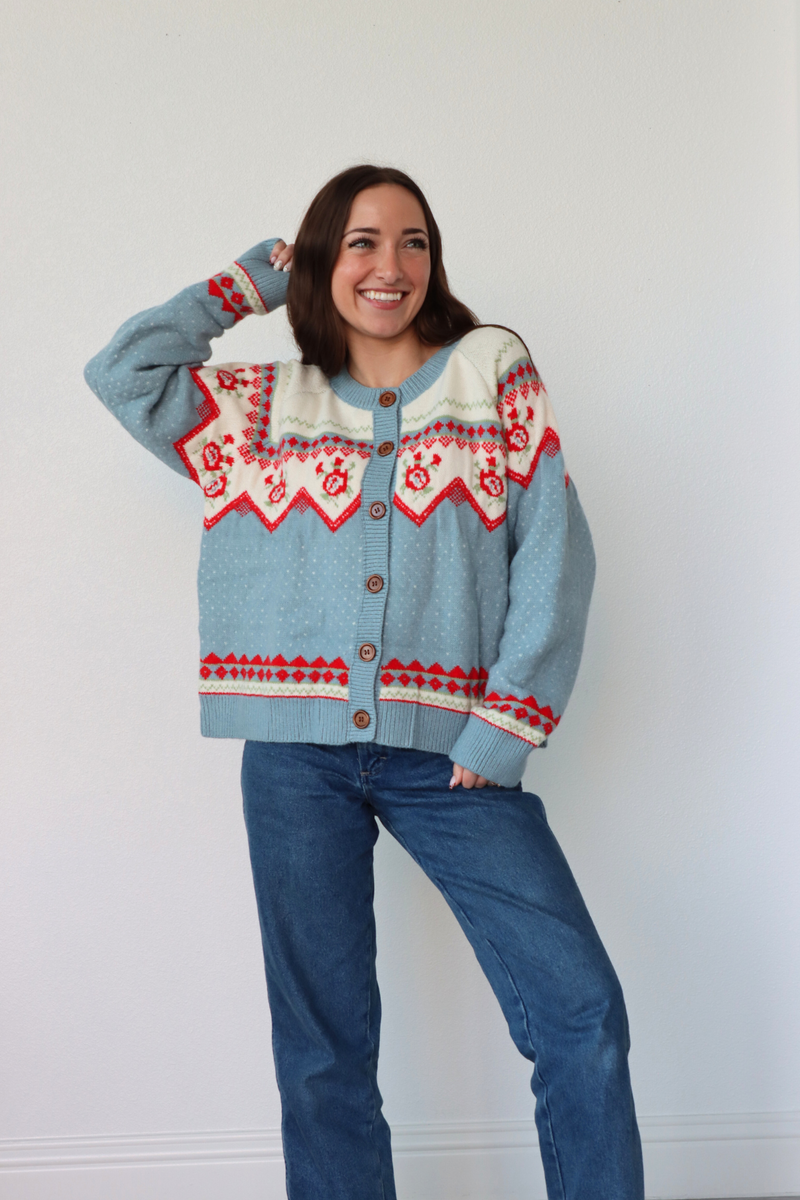 girl wearing light blue knit cardigan