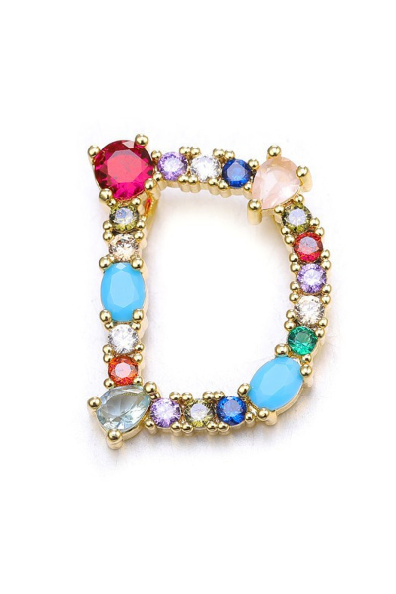 Multicolored gemstone ring with gold band on a white background