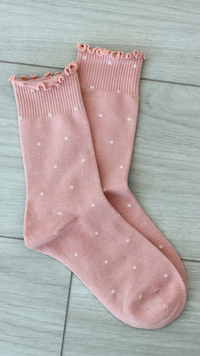 pink sock with white polka dots 