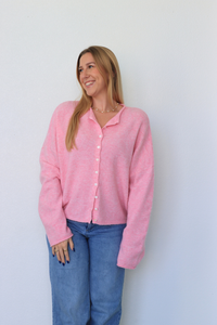 girl wearing pink cardigan