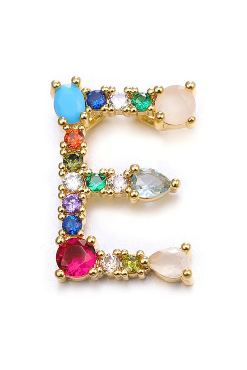 Gold earring with multicolored gemstones on a white background