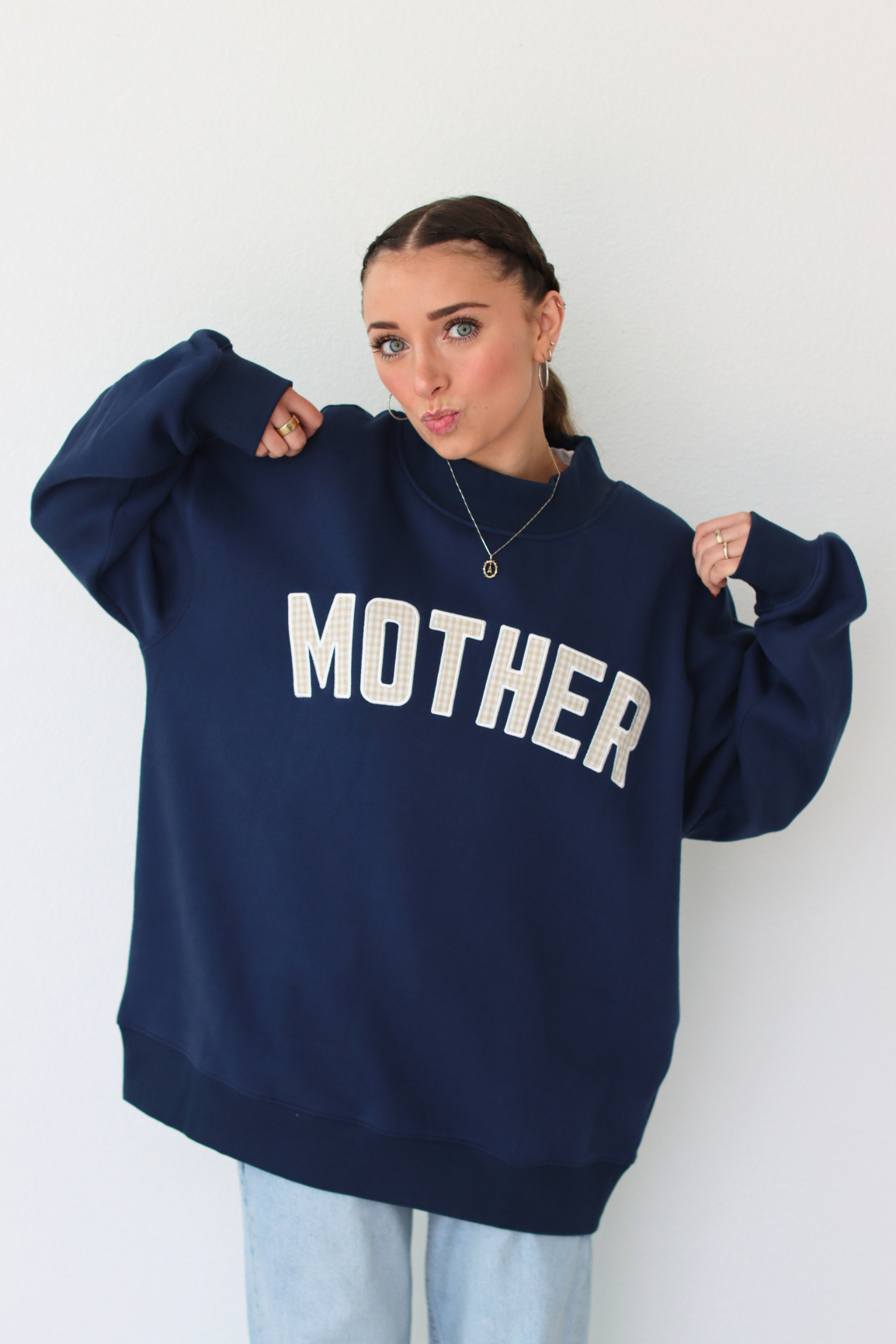 woman wearing navy blue MOTHER sweatshirt