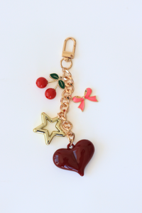 Keychain with heart, star, and cherry charms on a white background