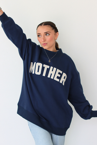 woman wearing navy blue MOTHER sweatshirt