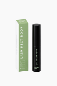 Lash Next Door lash serum shown with its green and white product box and the black applicator tube on a clean white background.
