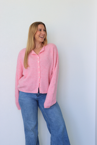 girl wearing pink cardigan