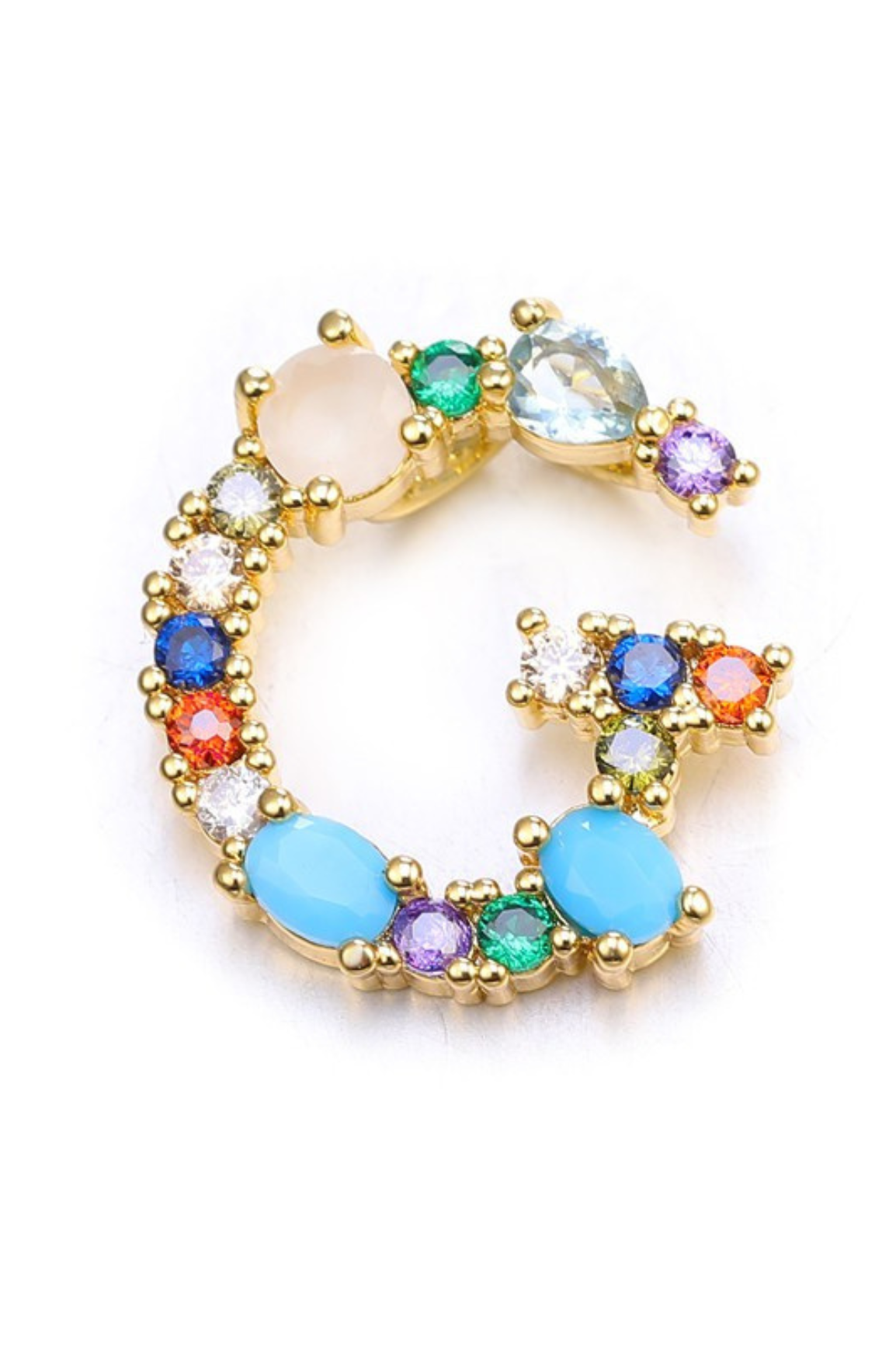 Multicolored gemstone ring with gold band on a white background