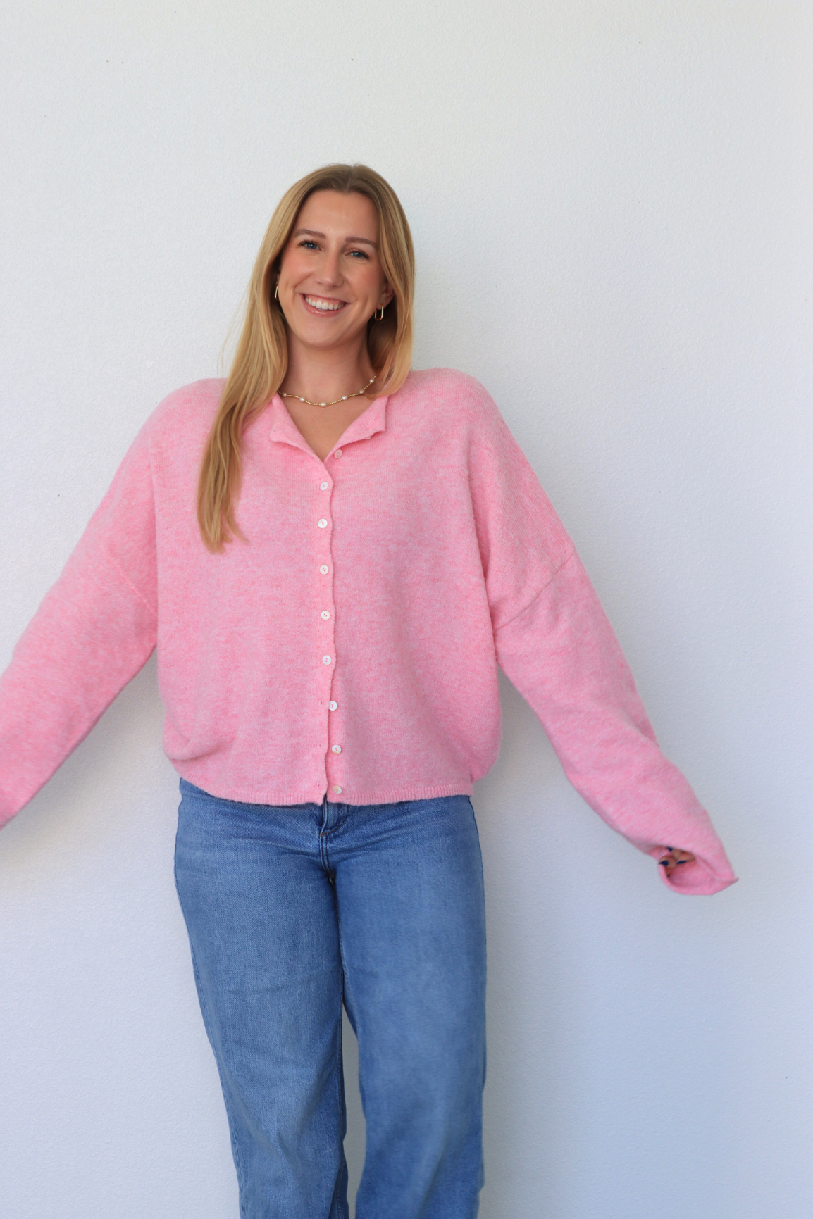 girl wearing pink cardigan