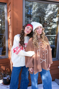 girl wearing brown gingerbread sweater