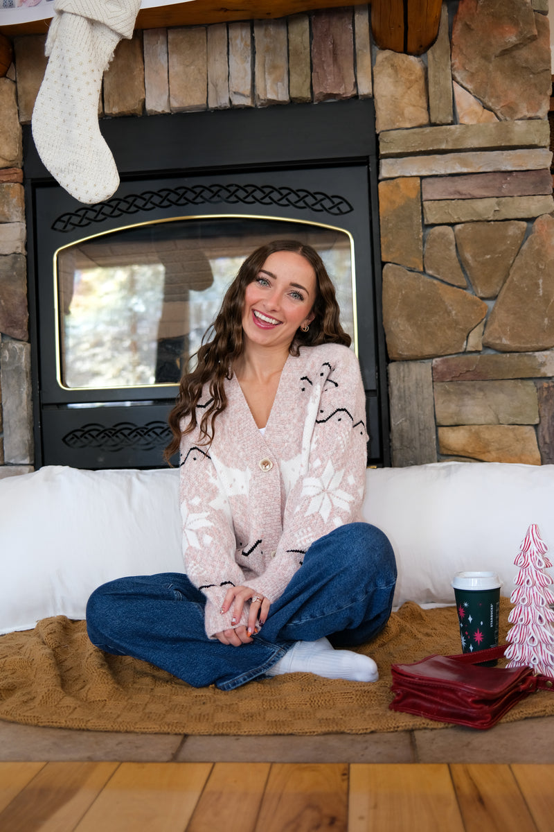 girl wearing pink holiday cardigan