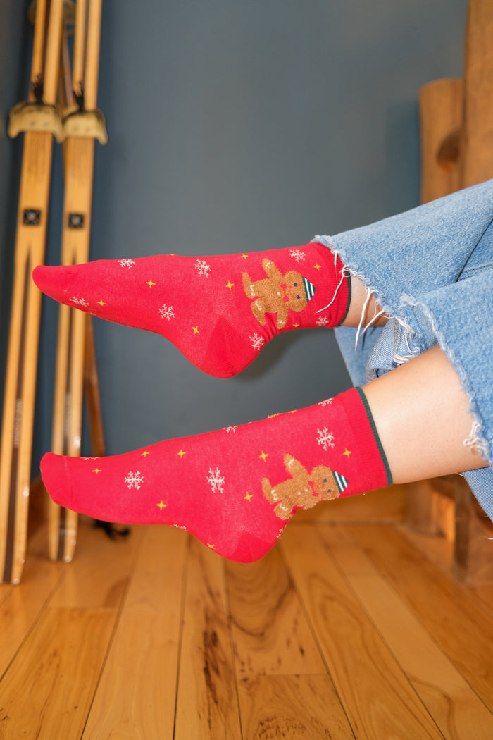 girl wearing red holiday socks