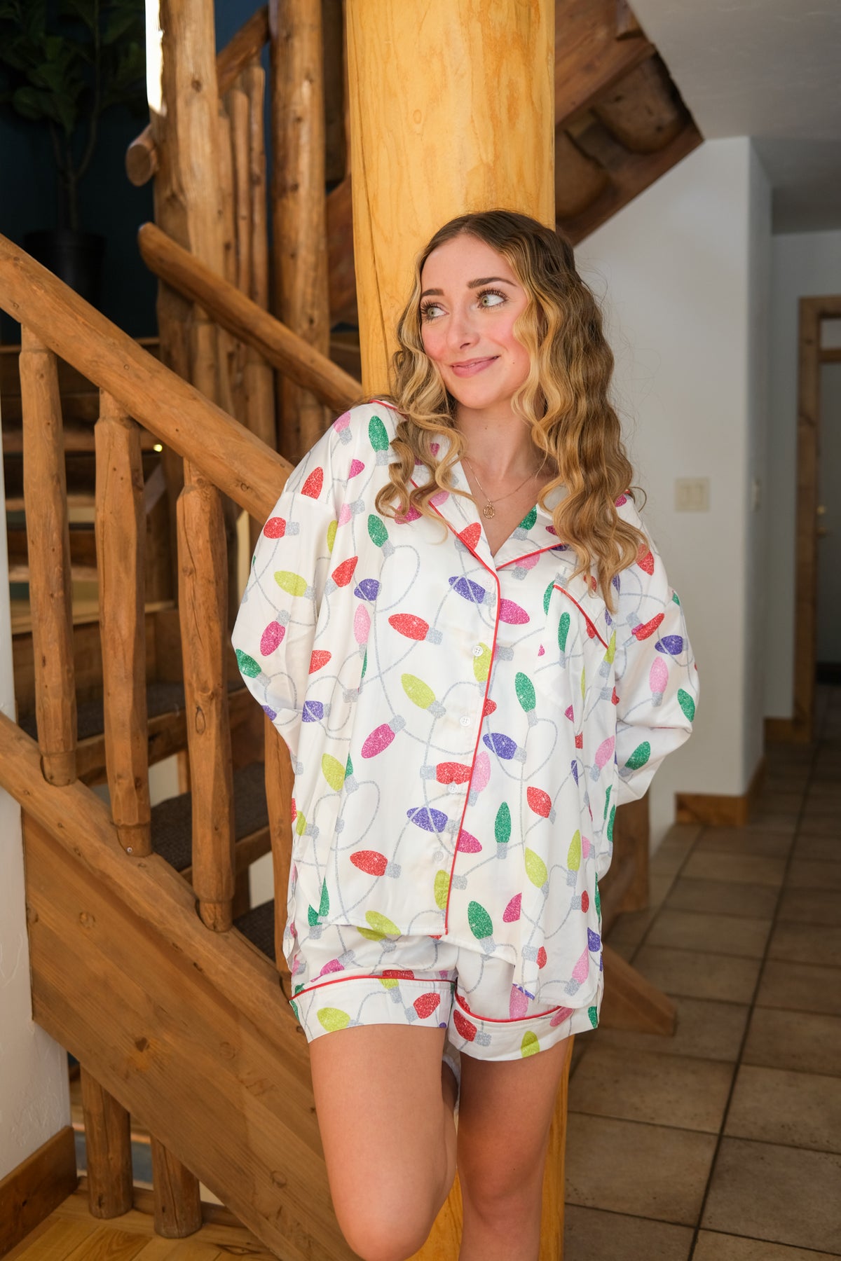girl wearing white holiday string lights pajama