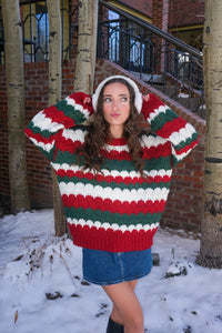 girl wearing red, green, and white striped sweater