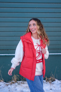 Woman wearing a white sweater with red ice skate design