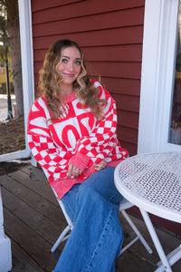 girl wearing red and white check joy sweater
