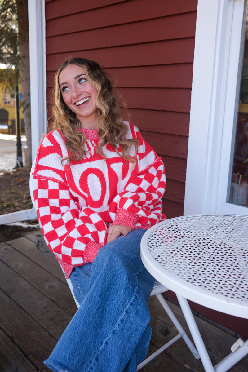 girl wearing red and white check joy sweater