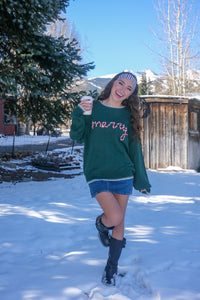 Woman wearing a green sweater with red text 