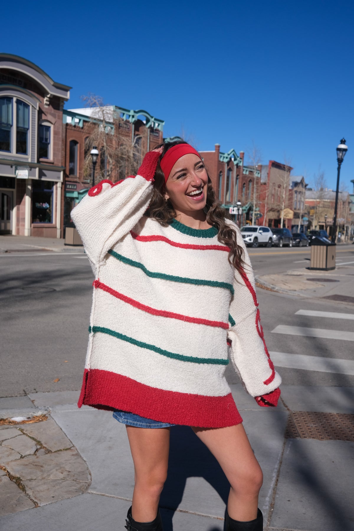 Woman wearing a colorful striped sweater 